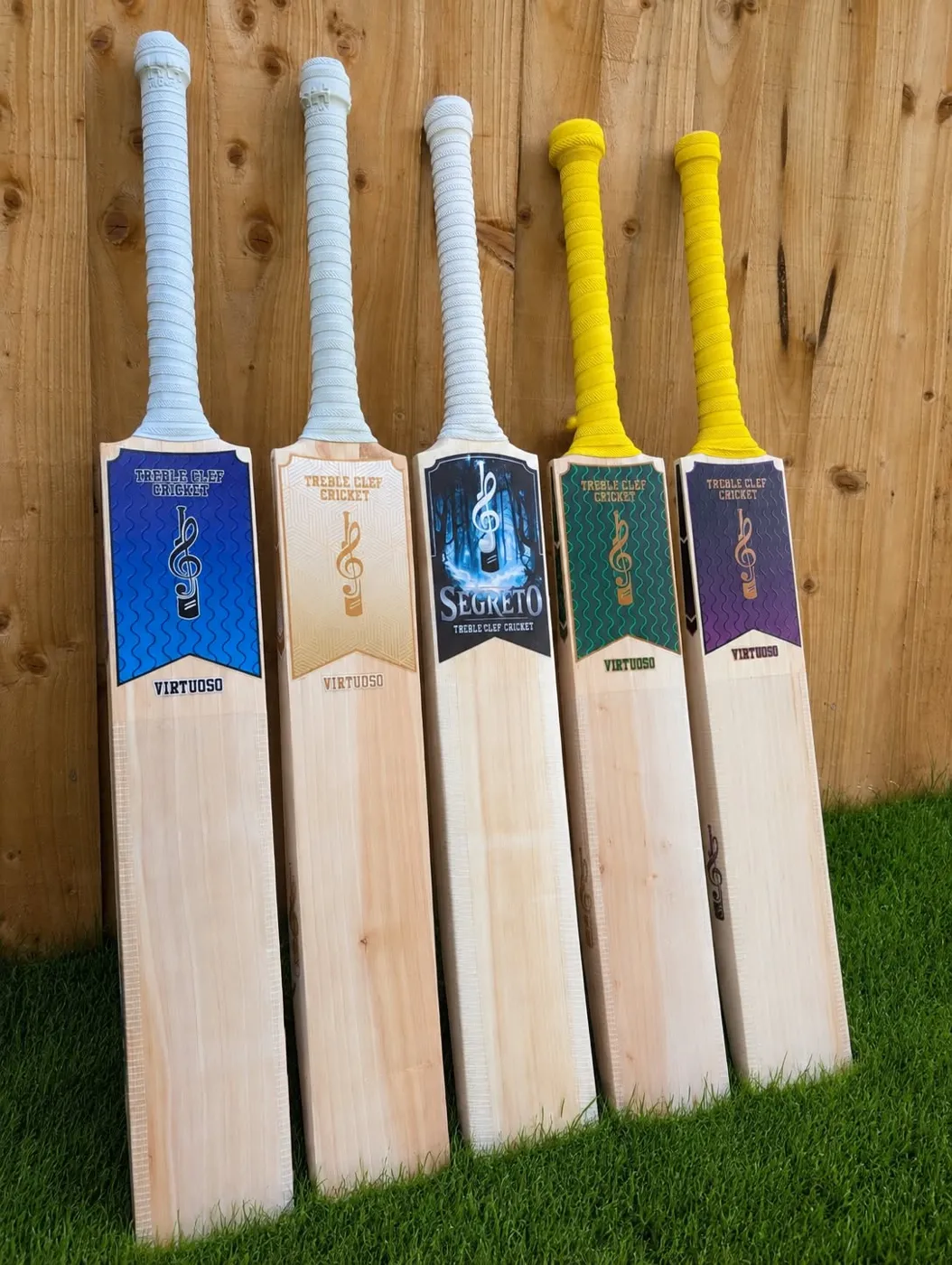 Virtuoso and Segreto bats lined up against a fence